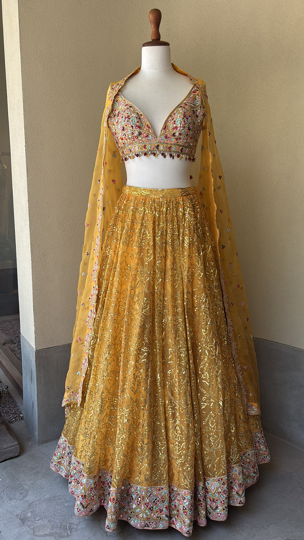 Orange Organza lehenga set with multi colored thread mirror and sequins