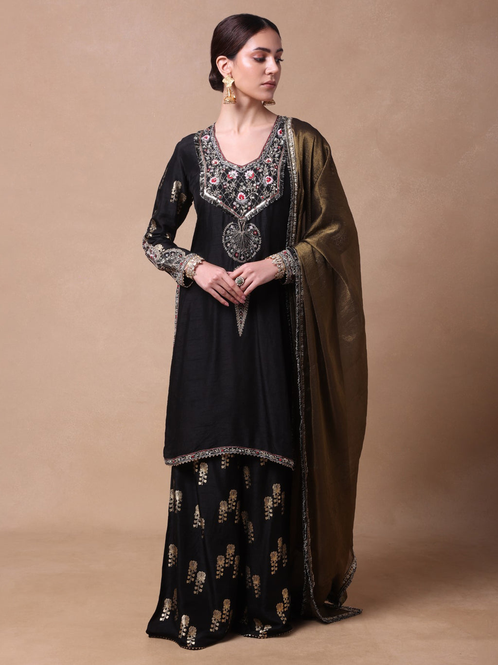 Black chanderi kurta and foil printed sharara paired with a tissue dupatta