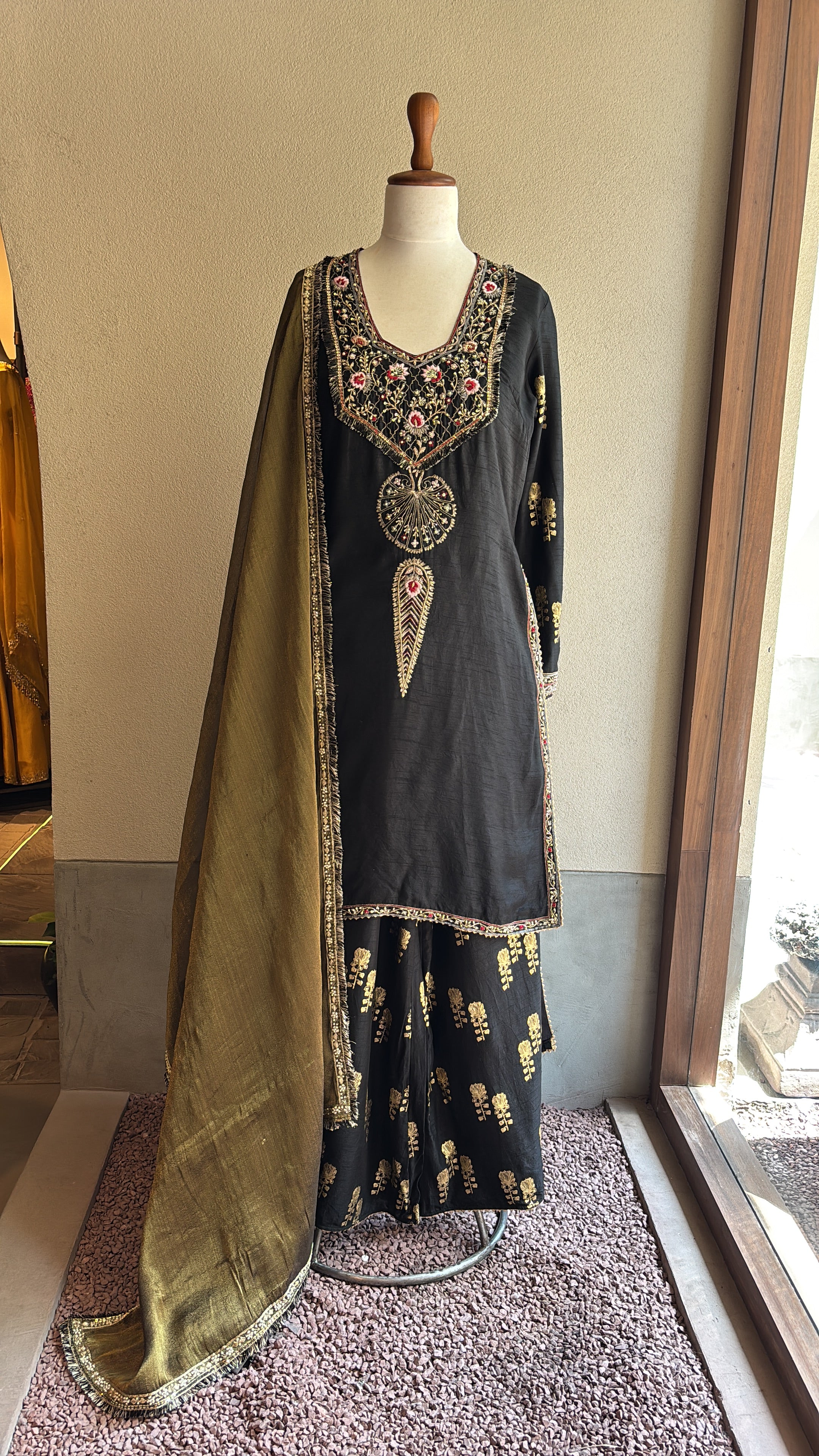 Black chanderi kurta and foil printed sharara paired with a tissue dupatta