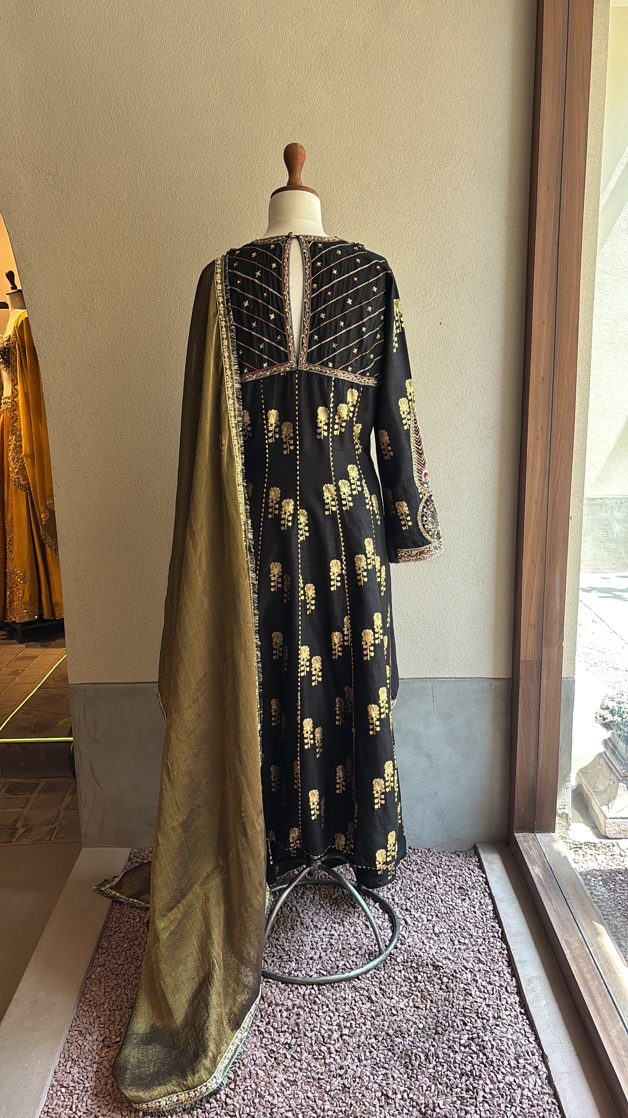 Black chanderi kurta and foil printed sharara paired with a tissue dupatta