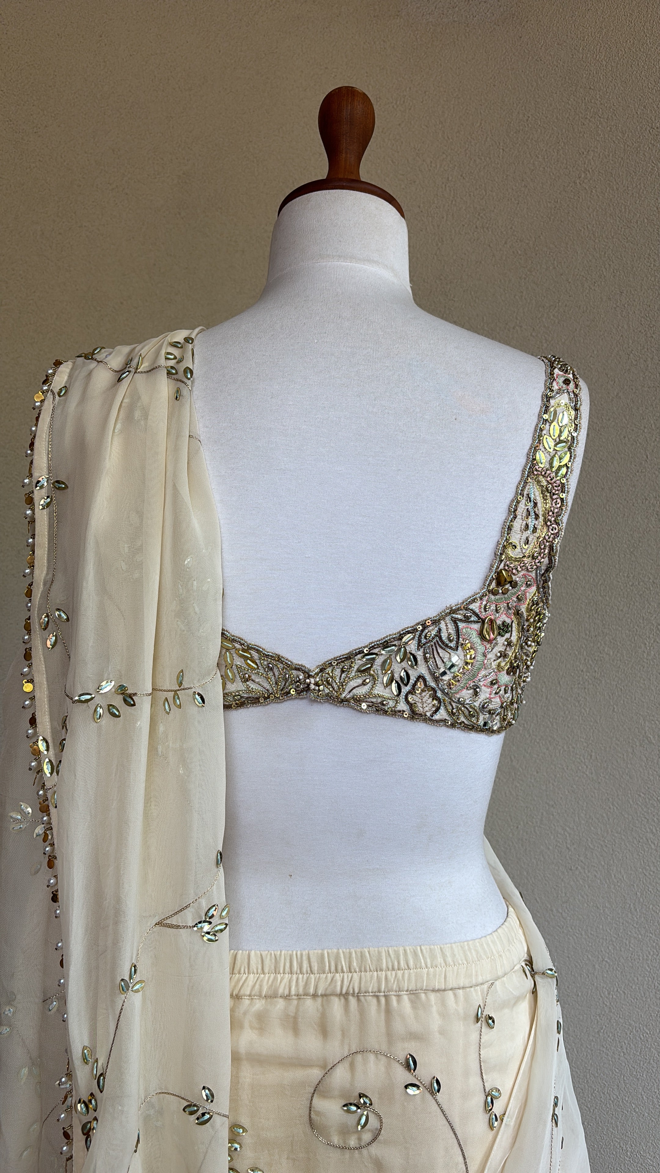 Ivory pre-draped sequins georgette organza saree paired with a hand embroidered blouse