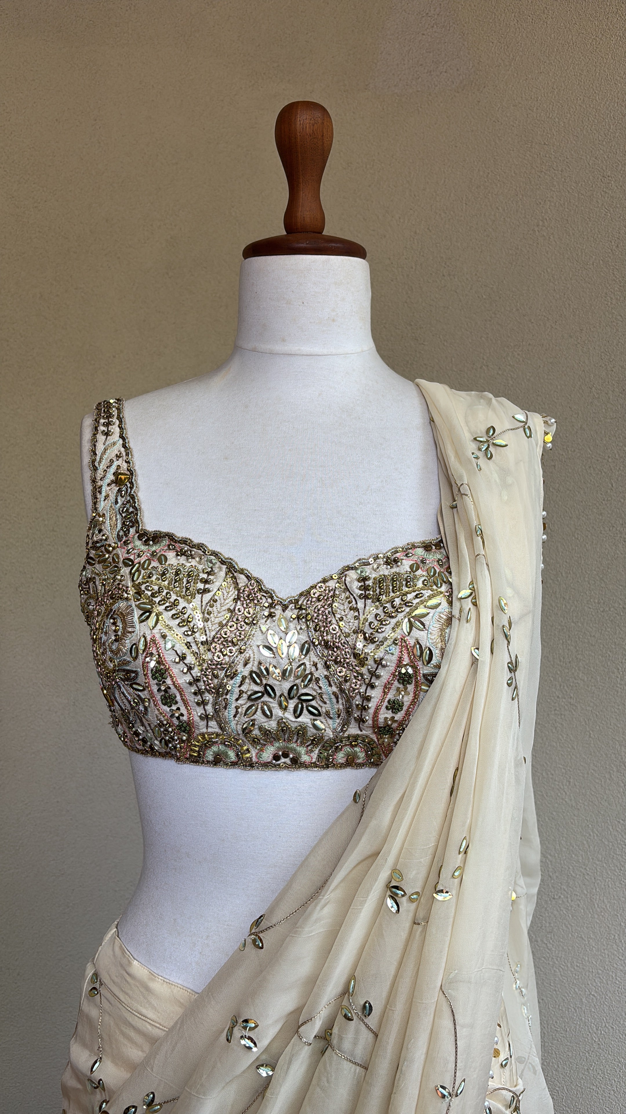 Ivory pre-draped sequins georgette organza saree paired with a hand embroidered blouse