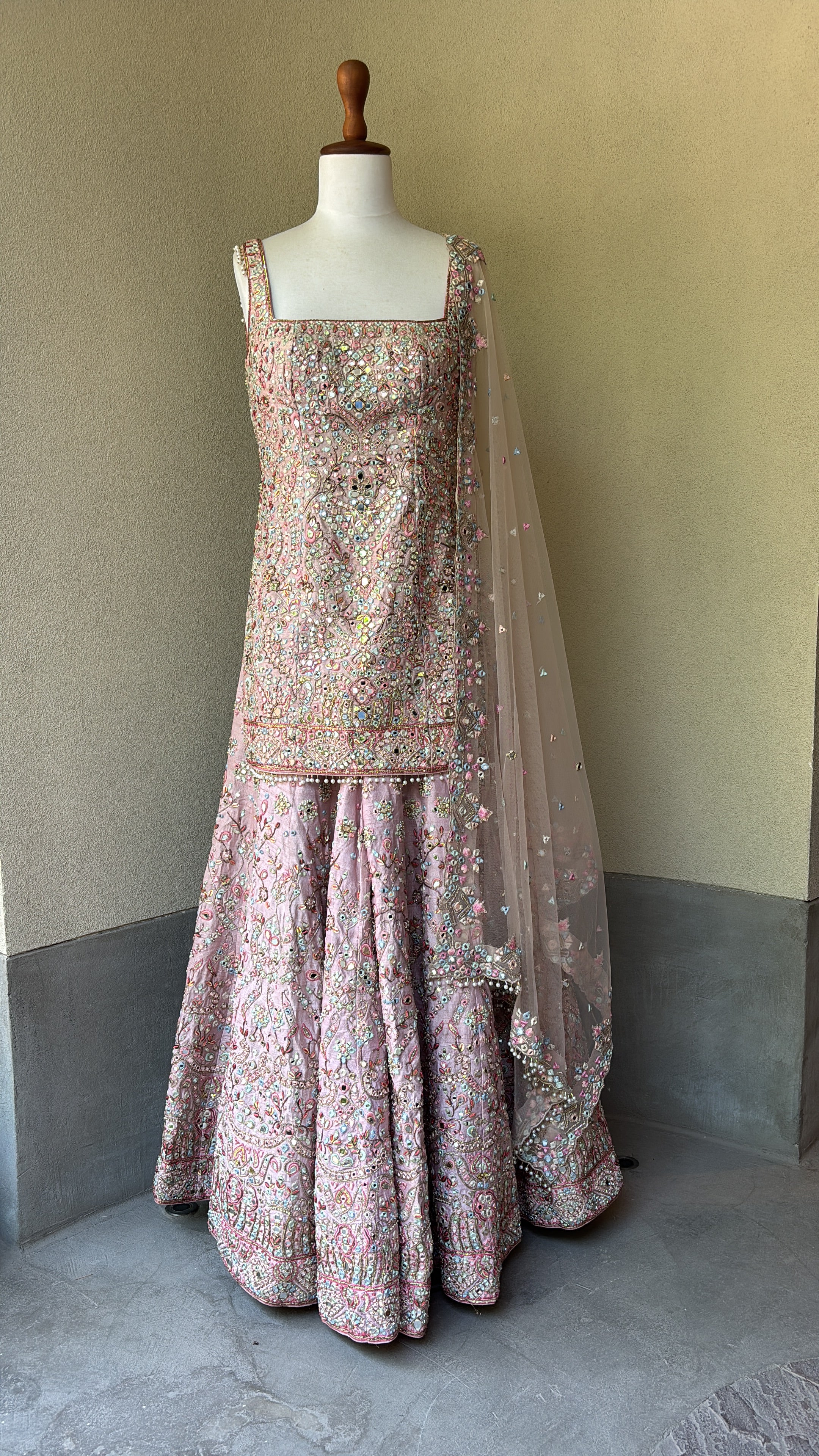 Pink rawsilk kurta and sharara paired with a net dupatta
