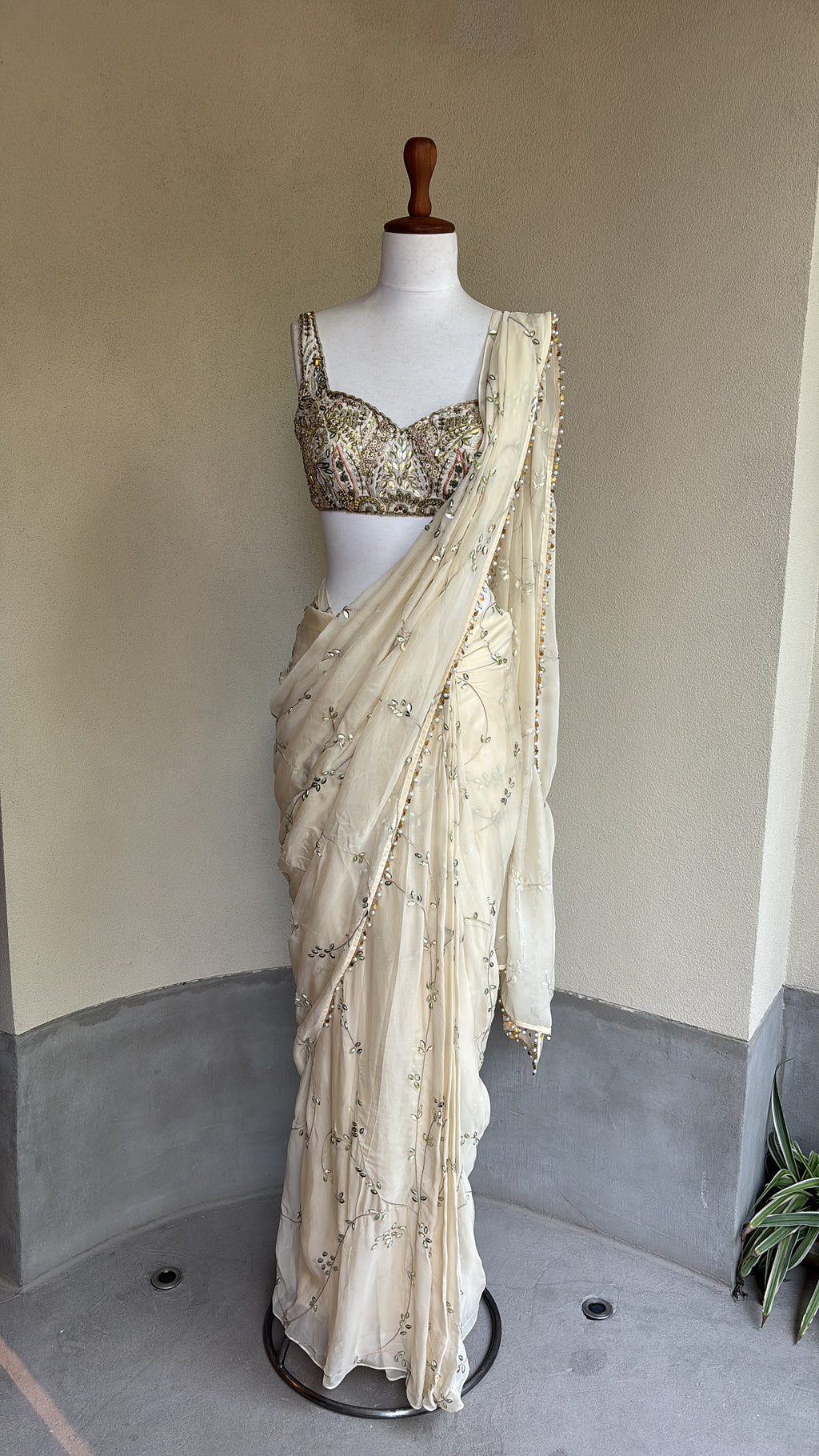 Ivory pre-draped sequins georgette organza saree paired with a hand embroidered blouse