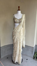 Ivory pre-draped sequins georgette organza saree paired with a hand embroidered blouse