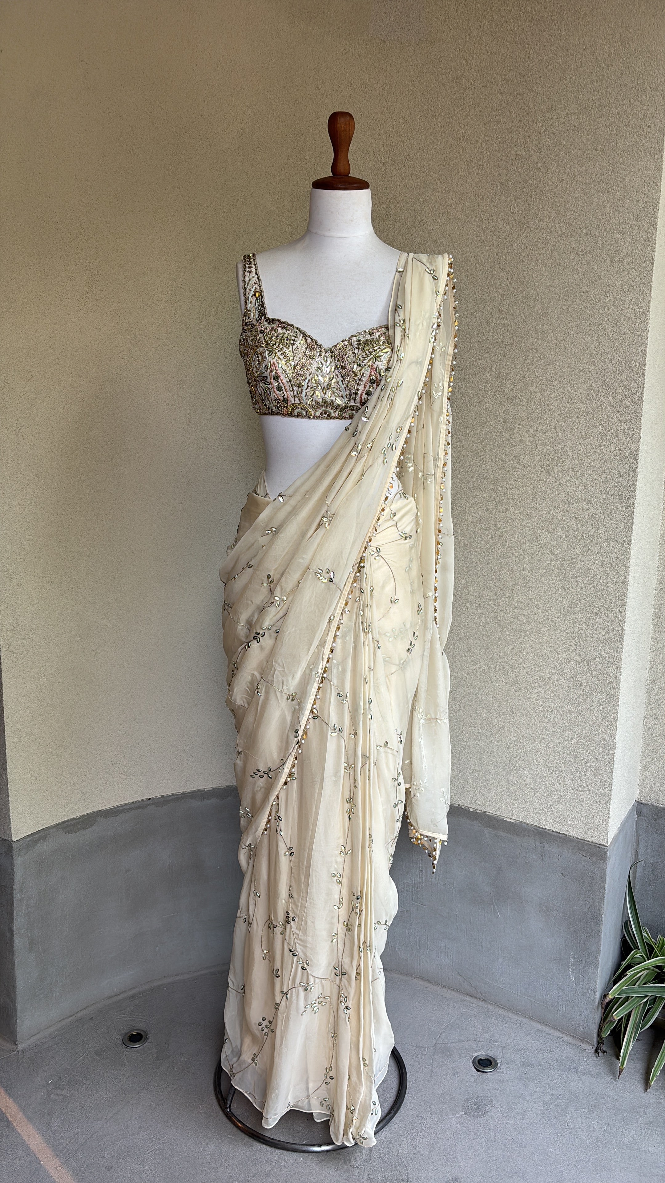 Ivory pre-draped sequins georgette organza saree paired with a hand embroidered blouse