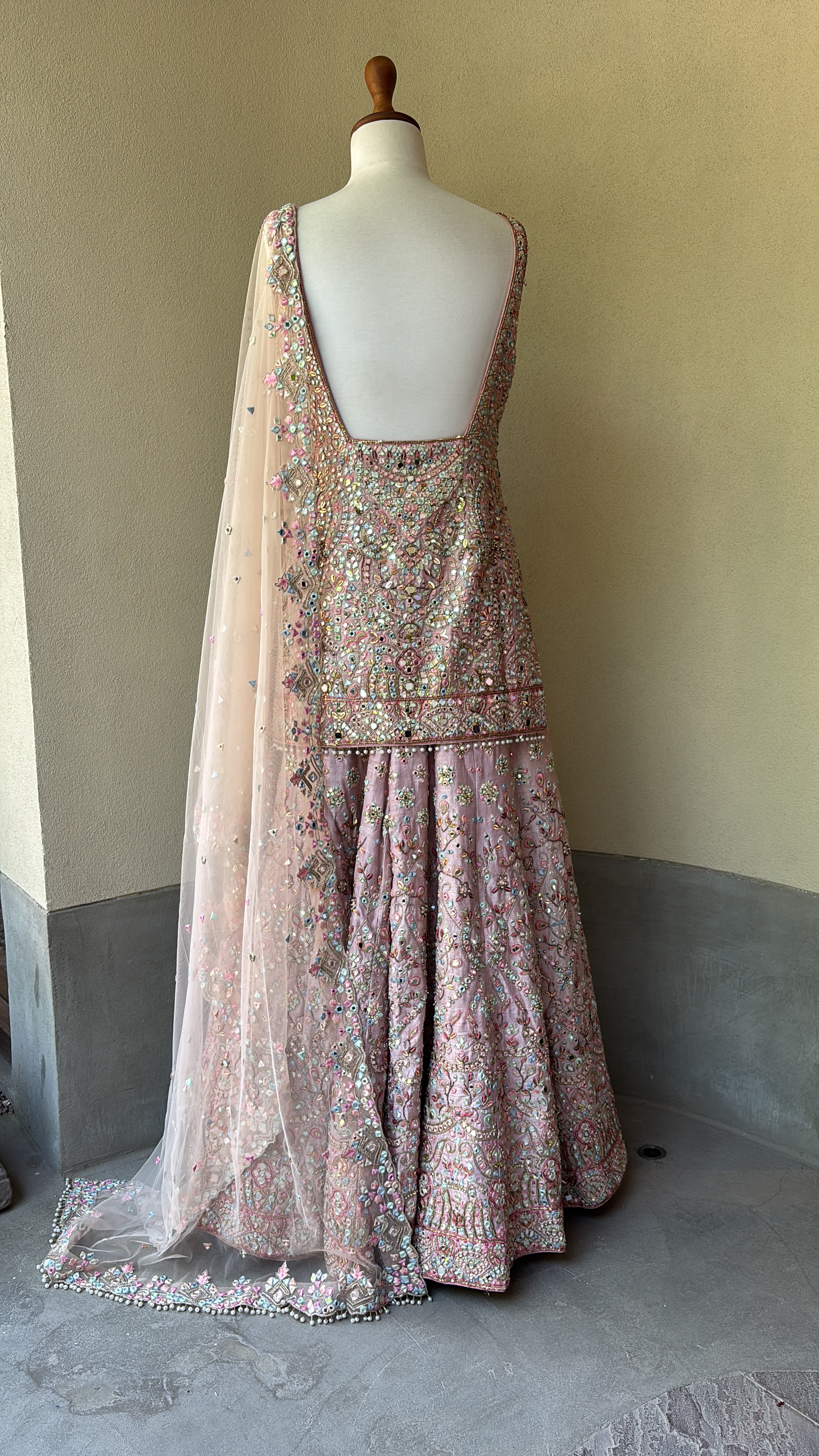Pink rawsilk kurta and sharara paired with a net dupatta