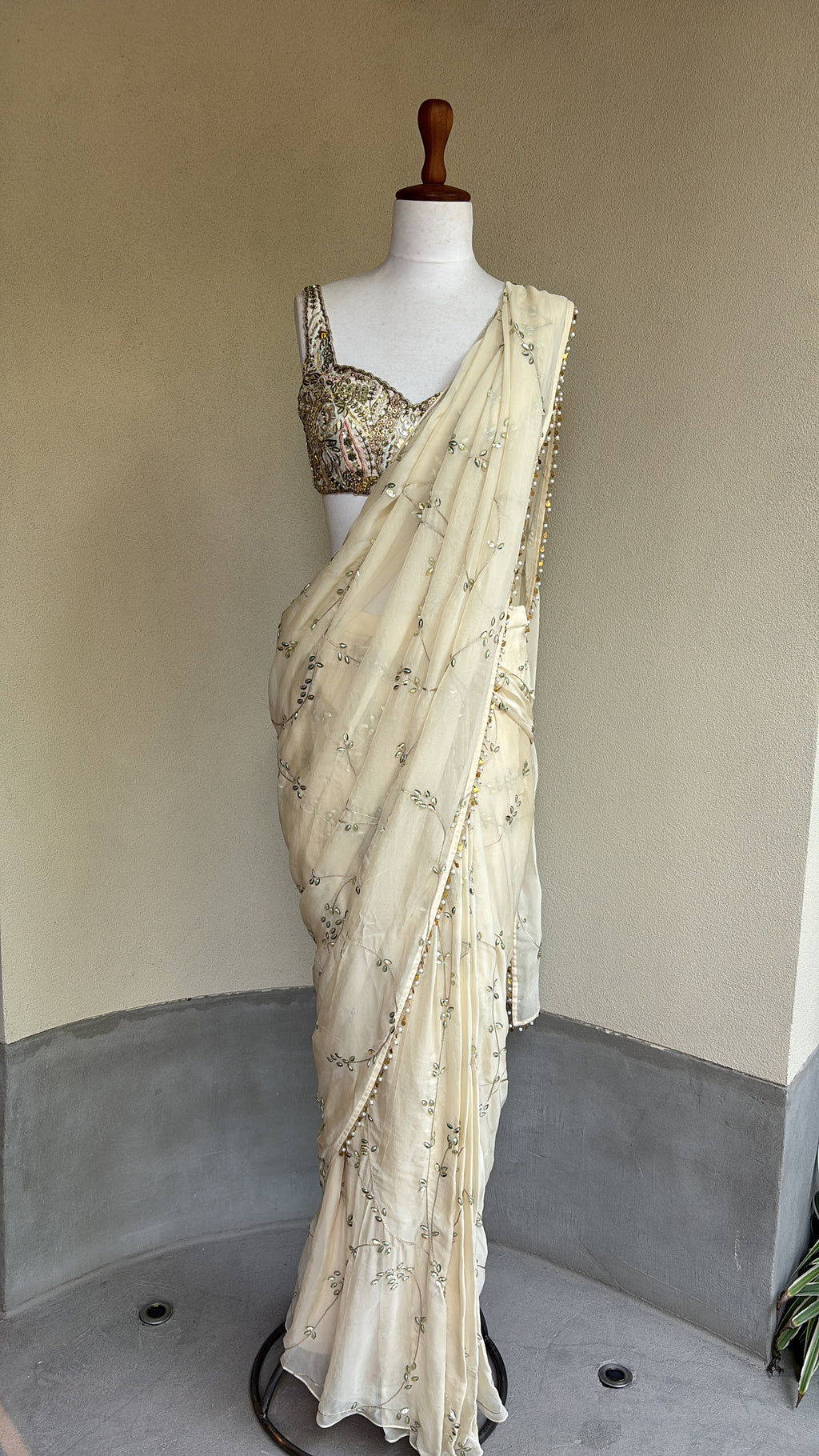 Ivory pre-draped sequins georgette organza saree paired with a hand embroidered blouse