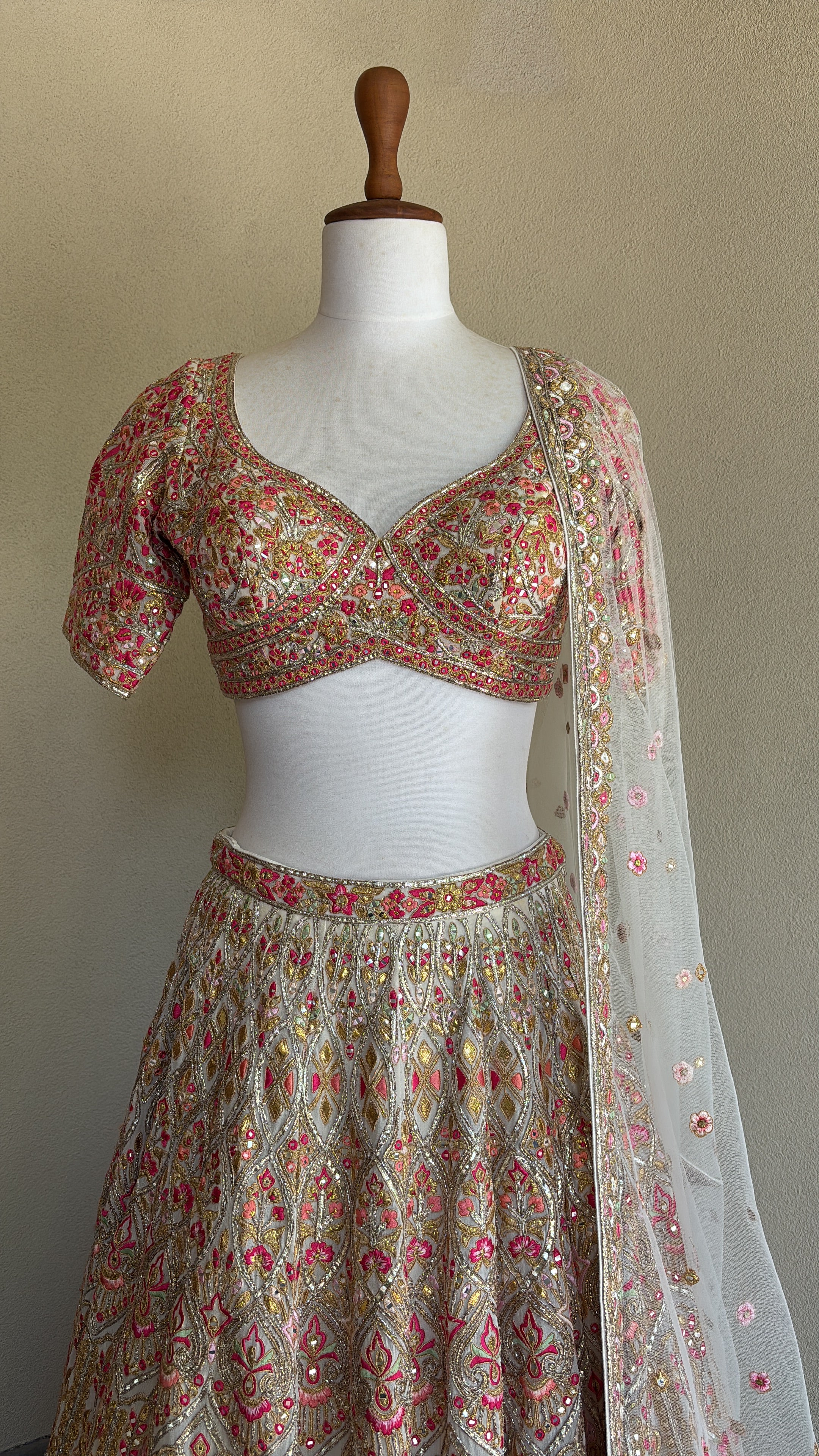 Ivory chanderi lehenga and blouse paired with a net dupatta