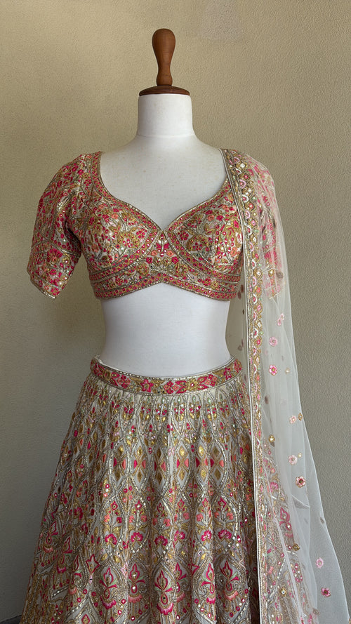 Ivory chanderi lehenga and blouse paired with a net dupatta