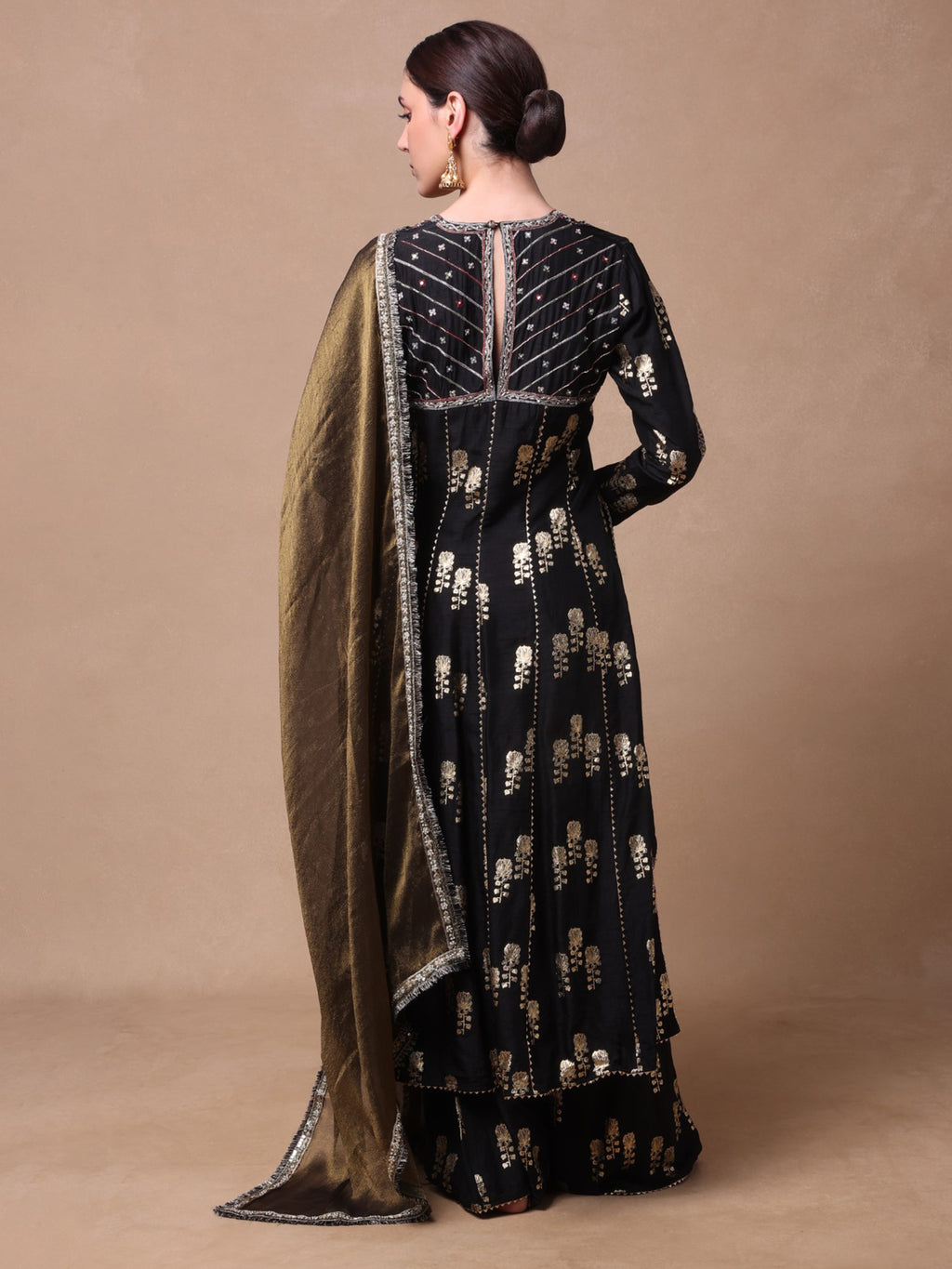 Black chanderi kurta and foil printed sharara paired with a tissue dupatta