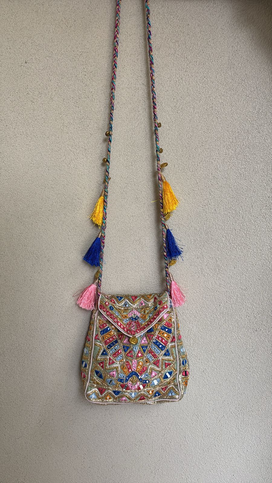 "Green multi colored bag with resham, gotta, dori, mirror work and tassel detailing on the sling "