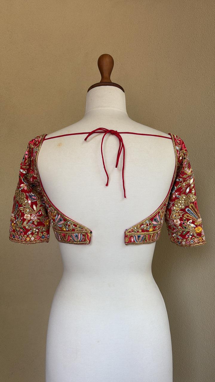 Red blouse with multi colored resham mirror and gota