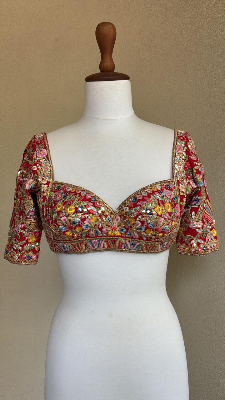 Red blouse with multi colored resham mirror and gota