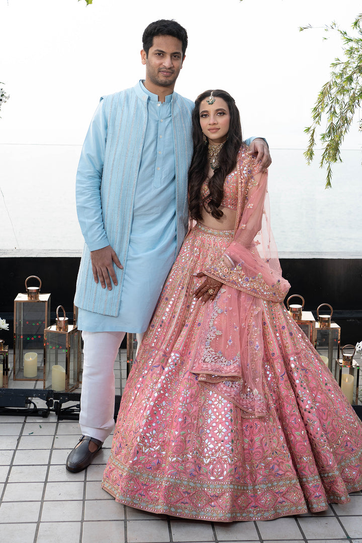 CHAHEL DHANDHANIA IN CORAL RAW SILK LEHENGA WITH FOIL, RESHAM